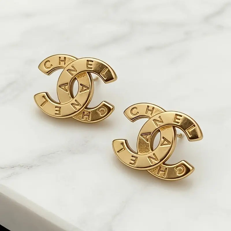 A Pair of Fashionable Letter Stud Earrings in Golden, Perfect for Daily Wear and Party Accessories. Luxurious and Stylish Jewelry with an Elegant Design, Crafted with High-quality Workmanship for a Fashionable Look Dropshipman